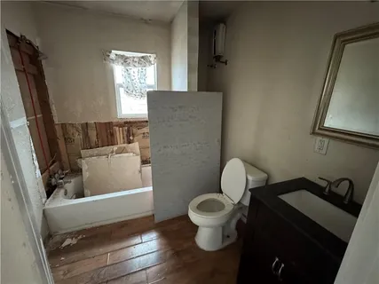a bathroom with a toilet a sink and a window