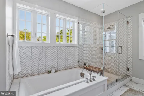 a bathroom with a sink toilet a mirror and shower