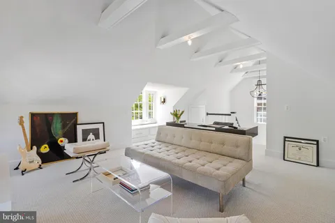 a living room with a couch and cabinets