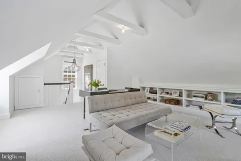 a view of a livingroom with an empty space and a window