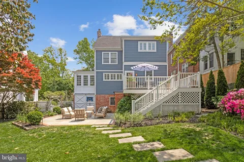 a view of backyard with seating area and green space