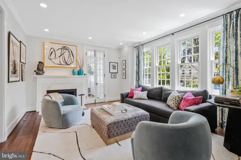 a living room with fireplace furniture and a flat screen tv