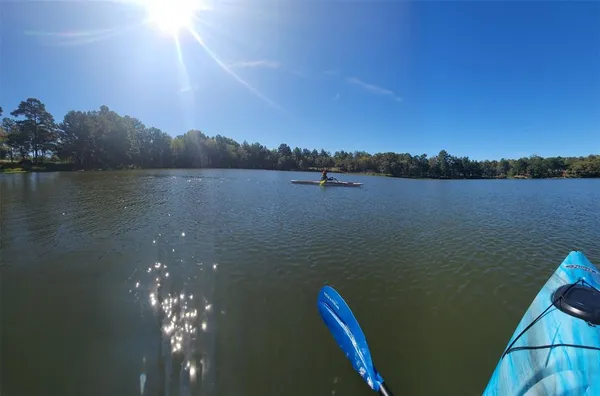 a view of green field with mountains in the background