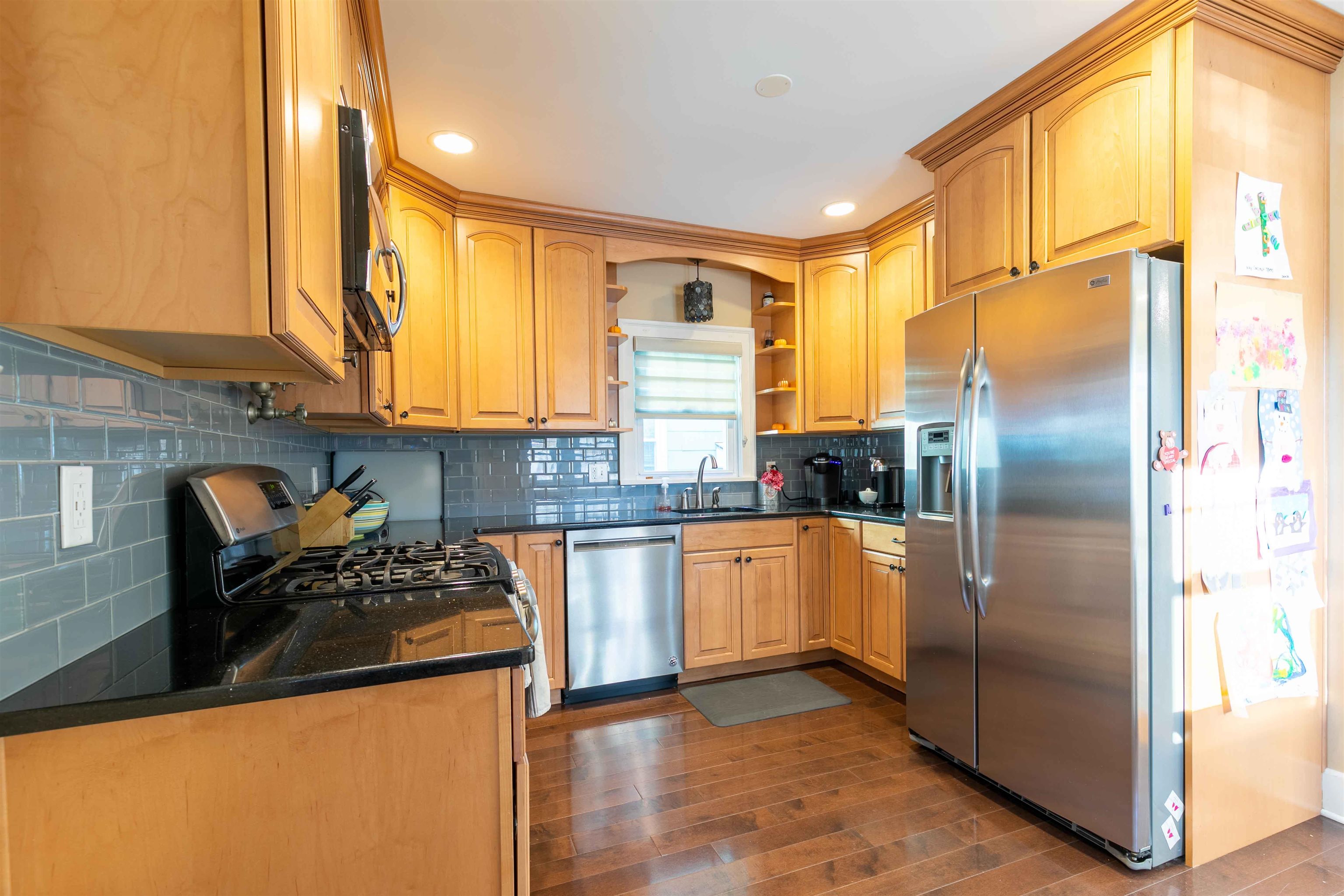 78 Jackson Avenue Rutherford, NJ 07070 - Photo 13 of 36 a kitchen with stainless steel appliances granite countertop a refrigerator a stove and a sink