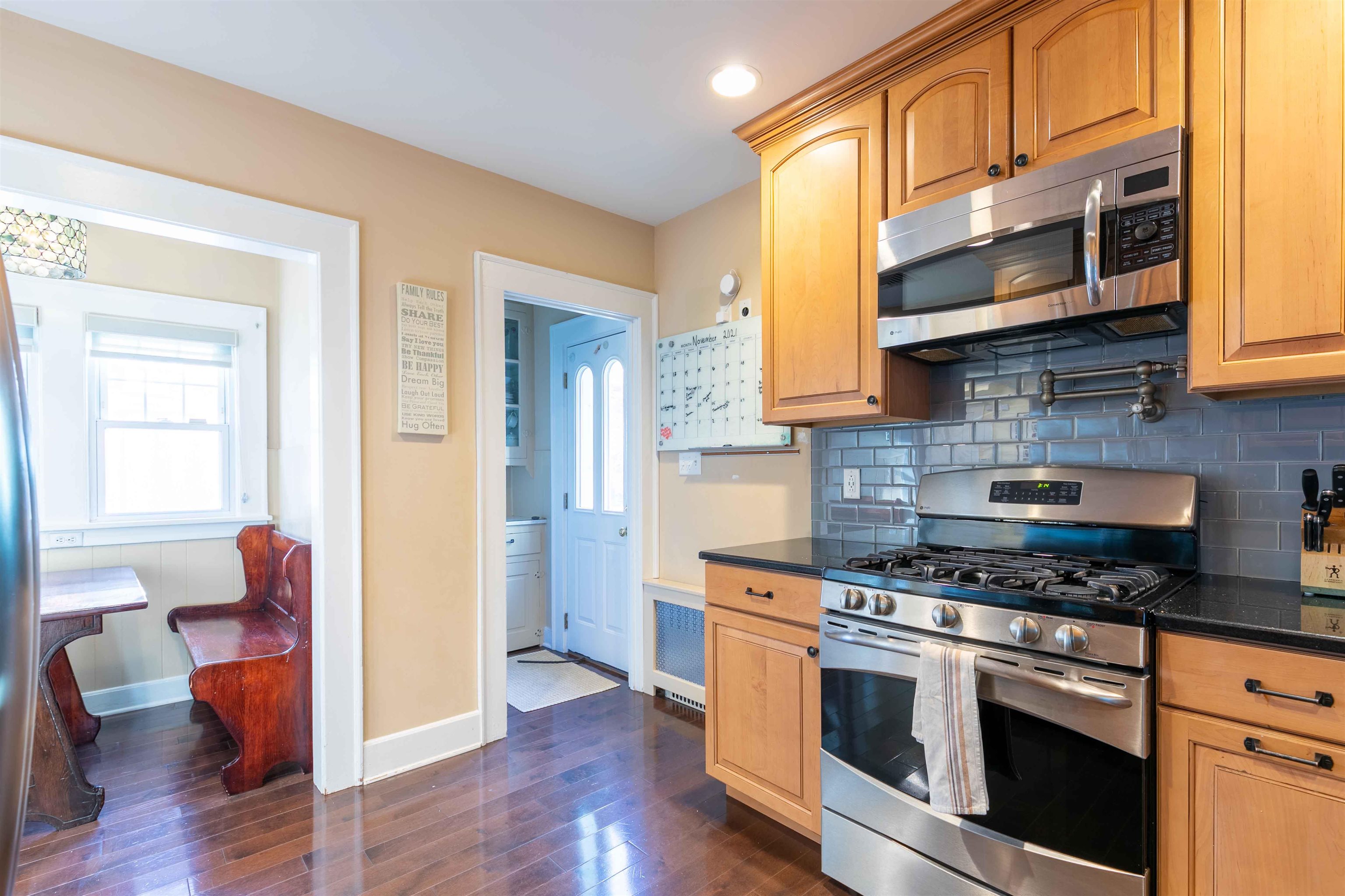 78 Jackson Avenue Rutherford, NJ 07070 - Photo 14 of 36 a kitchen with stainless steel appliances granite countertop wooden cabinets a stove a sink and a microwave
