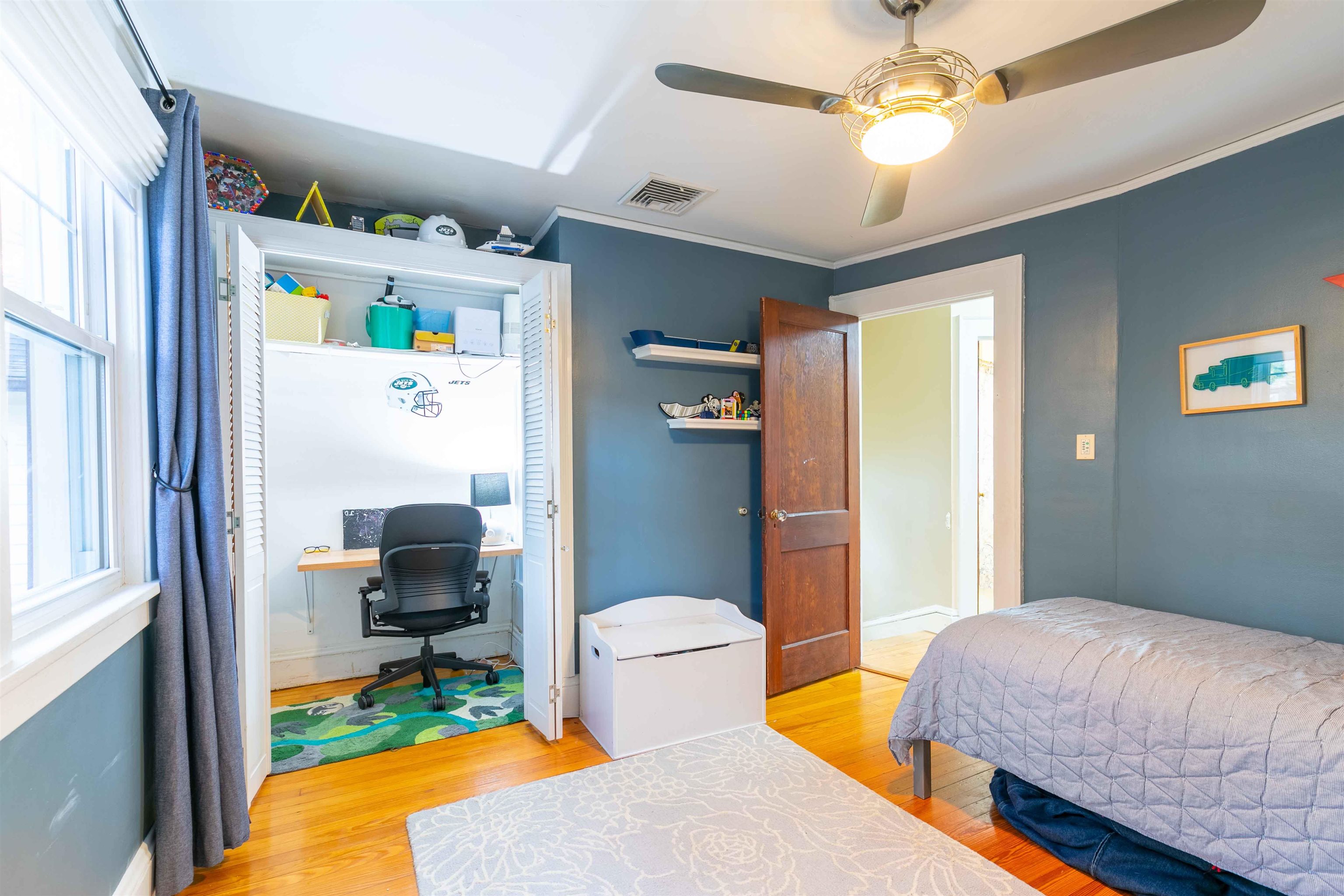 78 Jackson Avenue Rutherford, NJ 07070 - Photo 22 of 36 a bedroom with a bed and a chandelier