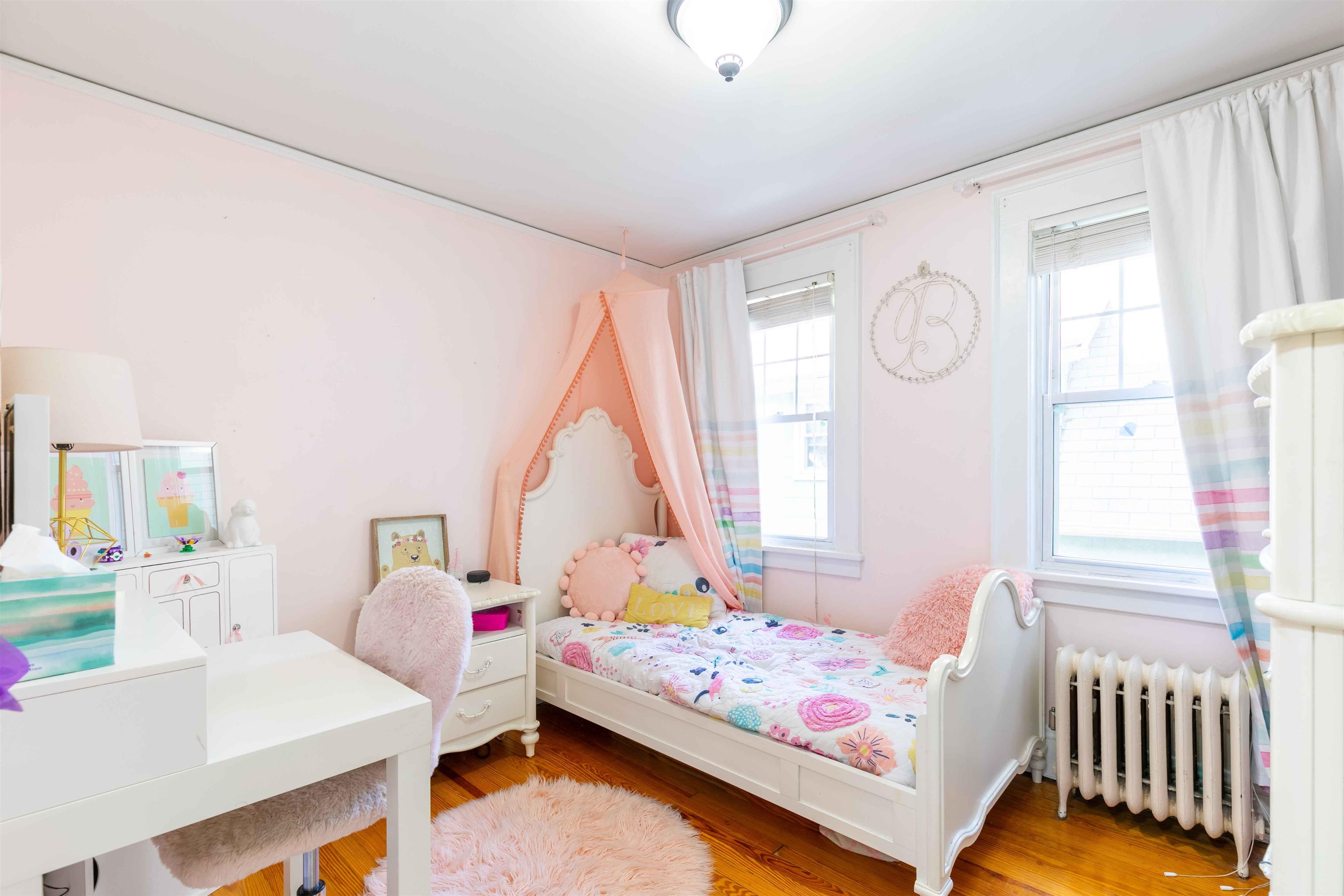 78 Jackson Avenue Rutherford, NJ 07070 - Photo 23 of 36 a bedroom with a bed and a table in it