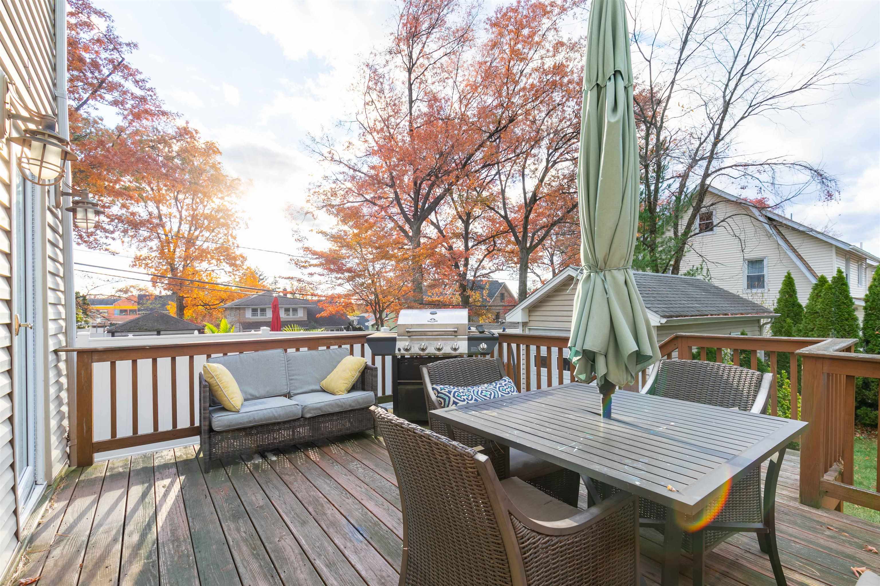 78 Jackson Avenue Rutherford, NJ 07070 - Photo 32 of 36 a roof deck with table and chairs and wooden floor