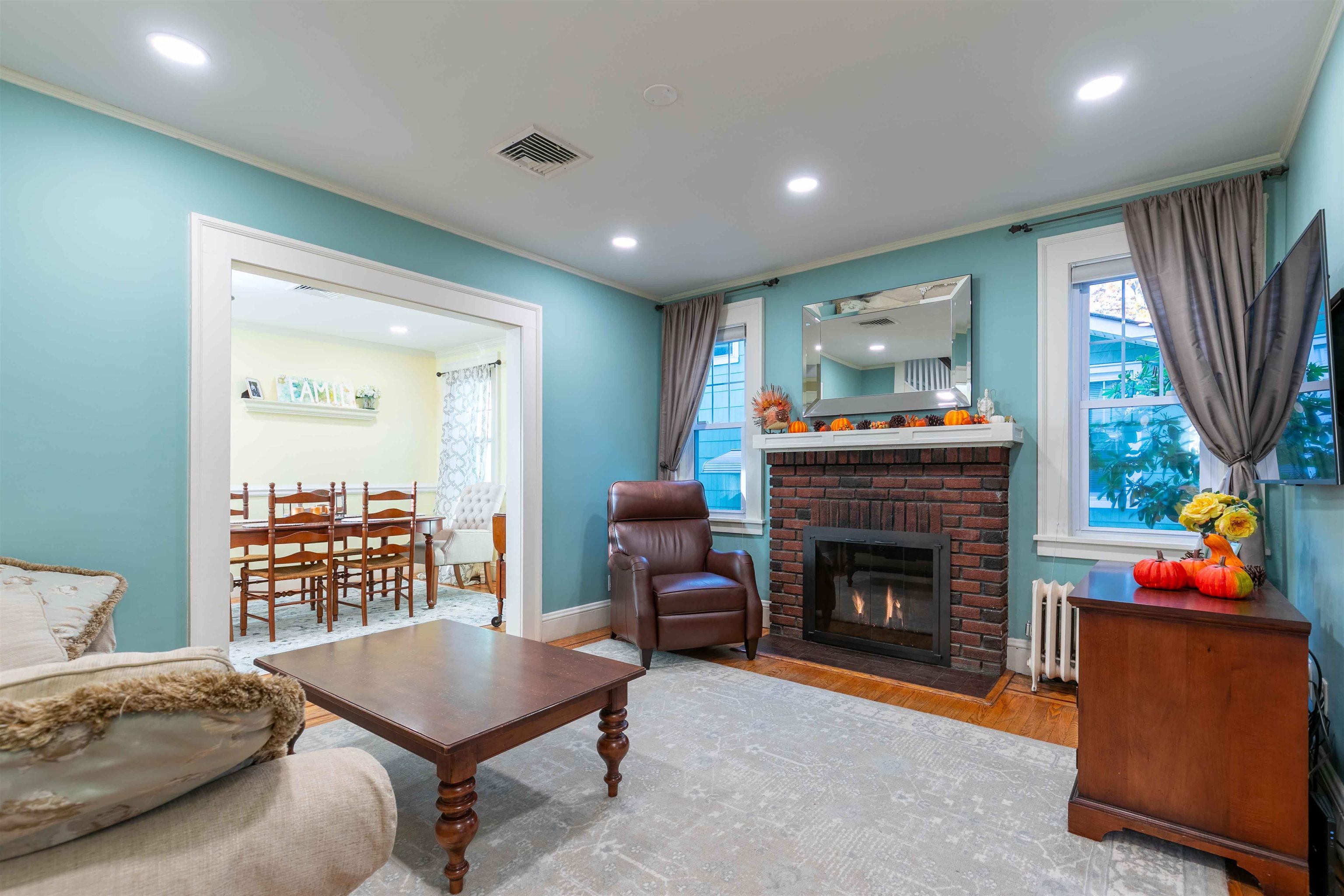 78 Jackson Avenue Rutherford, NJ 07070 - Photo 5 of 36 a living room with furniture a fireplace and a flat screen tv