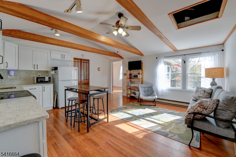 9 Woods Road Branchville, NJ 07826 - Photo 3 of 22 a living room with furniture a dining table and chairs with wooden floor