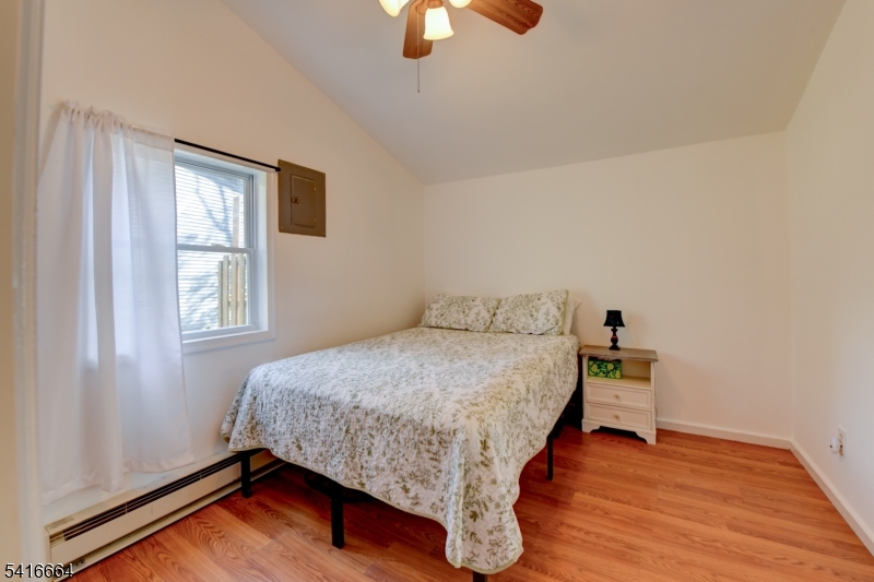 9 Woods Road Branchville, NJ 07826 - Photo 7 of 22 a bedroom with a bed and wooden floor