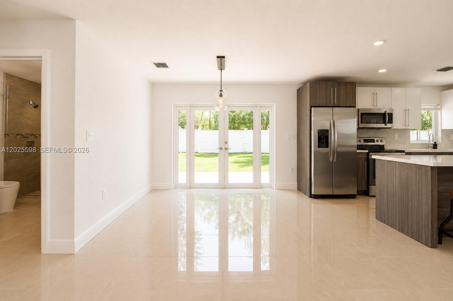 9421 Southwest 150th Street Miami, FL 33176 - Photo 8 of 31 a kitchen with stainless steel appliances a refrigerator sink and cabinets