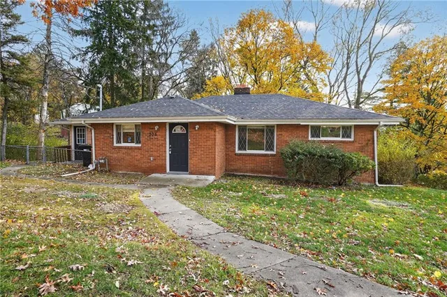 a front view of a house with a garden
