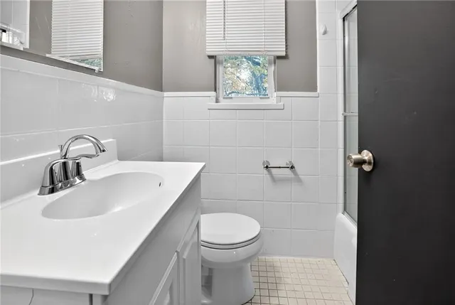 a bathroom with a sink a toilet and a window