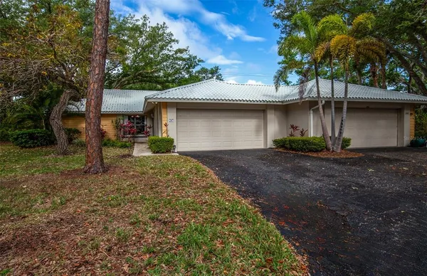 a front view of a house with a yard and a garage