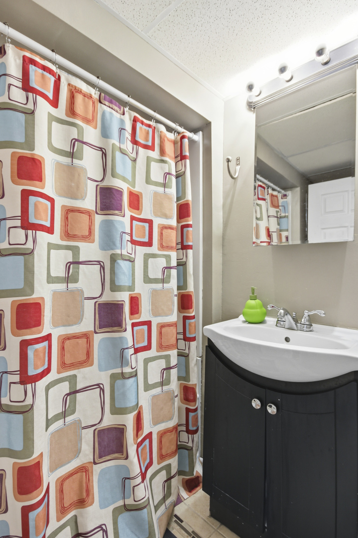 18655 Sherman Street Lansing, IL 60438 - Photo 16 of 21 a bathroom with a sink toilet and shower