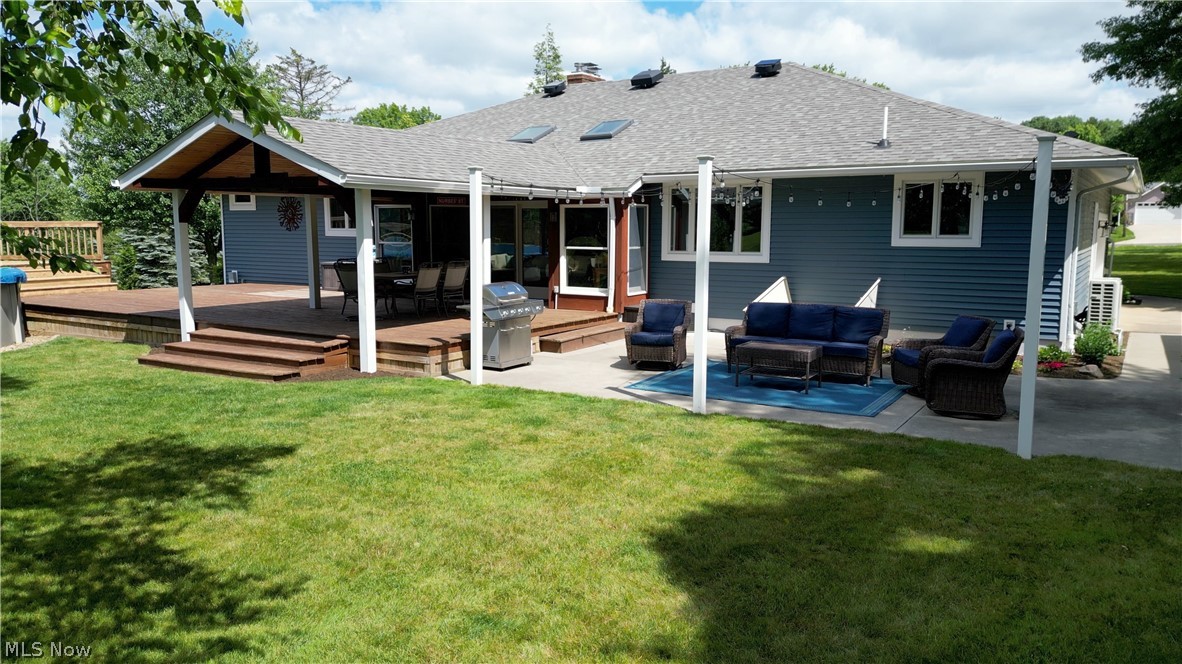 3362 Granger Road Medina, OH 44256 - Photo 45 of 49 Rear view of house featuring a yard, an outdoor hangout area, and a wooden deck