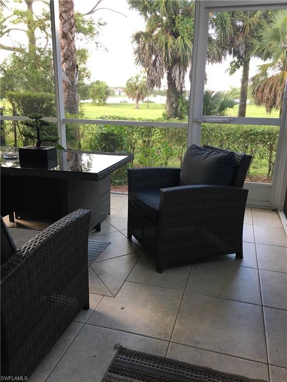 884 Hampton Circle, Unit 159 Naples, FL 34105 - Photo 5 of 28 a view of a couches in a patio with a lake view