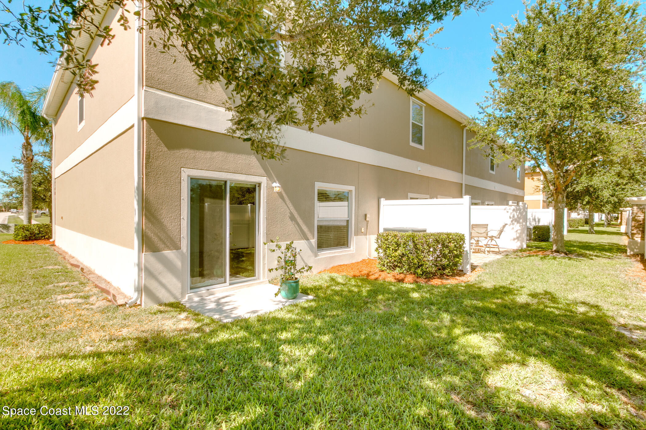 2525 Revolution Street, Unit 104 Melbourne, FL 32935 - Photo 12 of 37 a view of a house with a big yard and large tree
