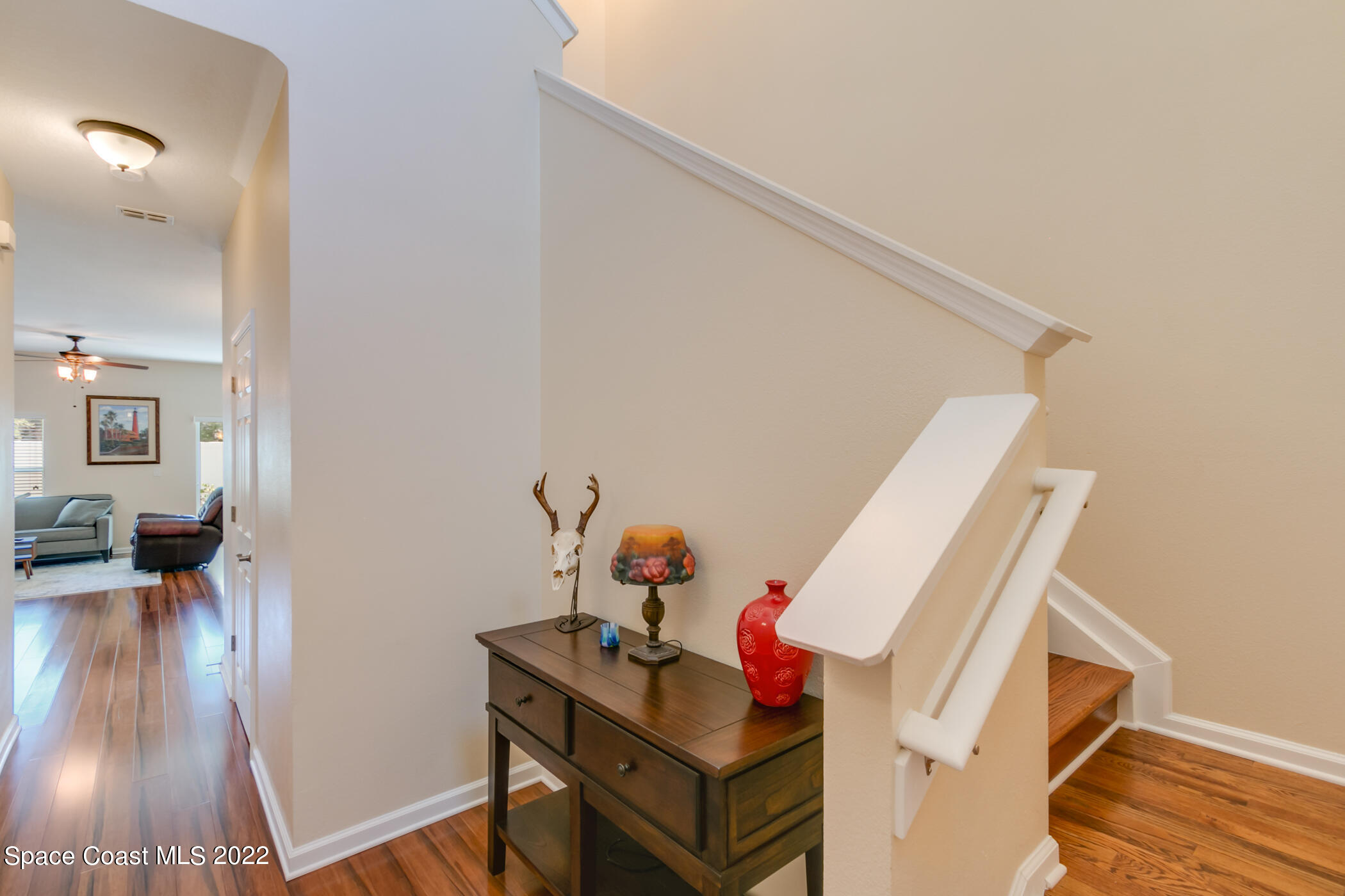2525 Revolution Street, Unit 104 Melbourne, FL 32935 - Photo 14 of 37 a living room with furniture and a wooden floor