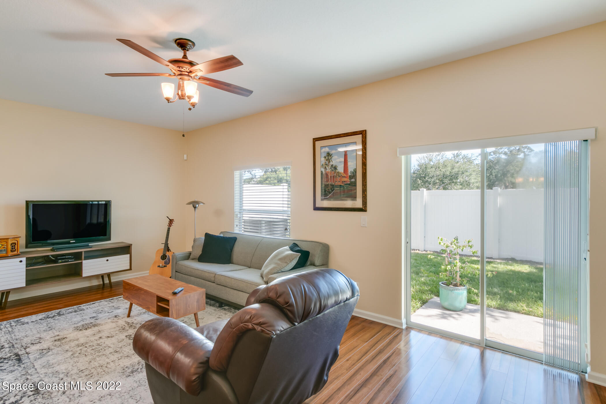 2525 Revolution Street, Unit 104 Melbourne, FL 32935 - Photo 22 of 37 a living room with furniture and a flat screen tv