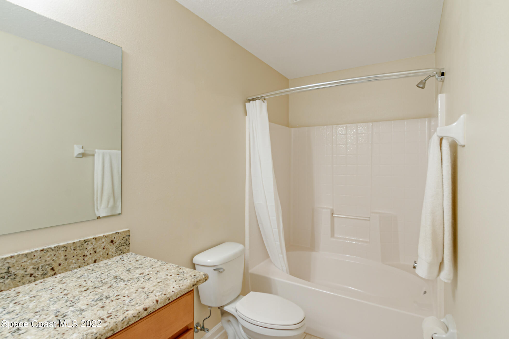 2525 Revolution Street, Unit 104 Melbourne, FL 32935 - Photo 35 of 37 a bathroom with a granite countertop sink toilet and shower