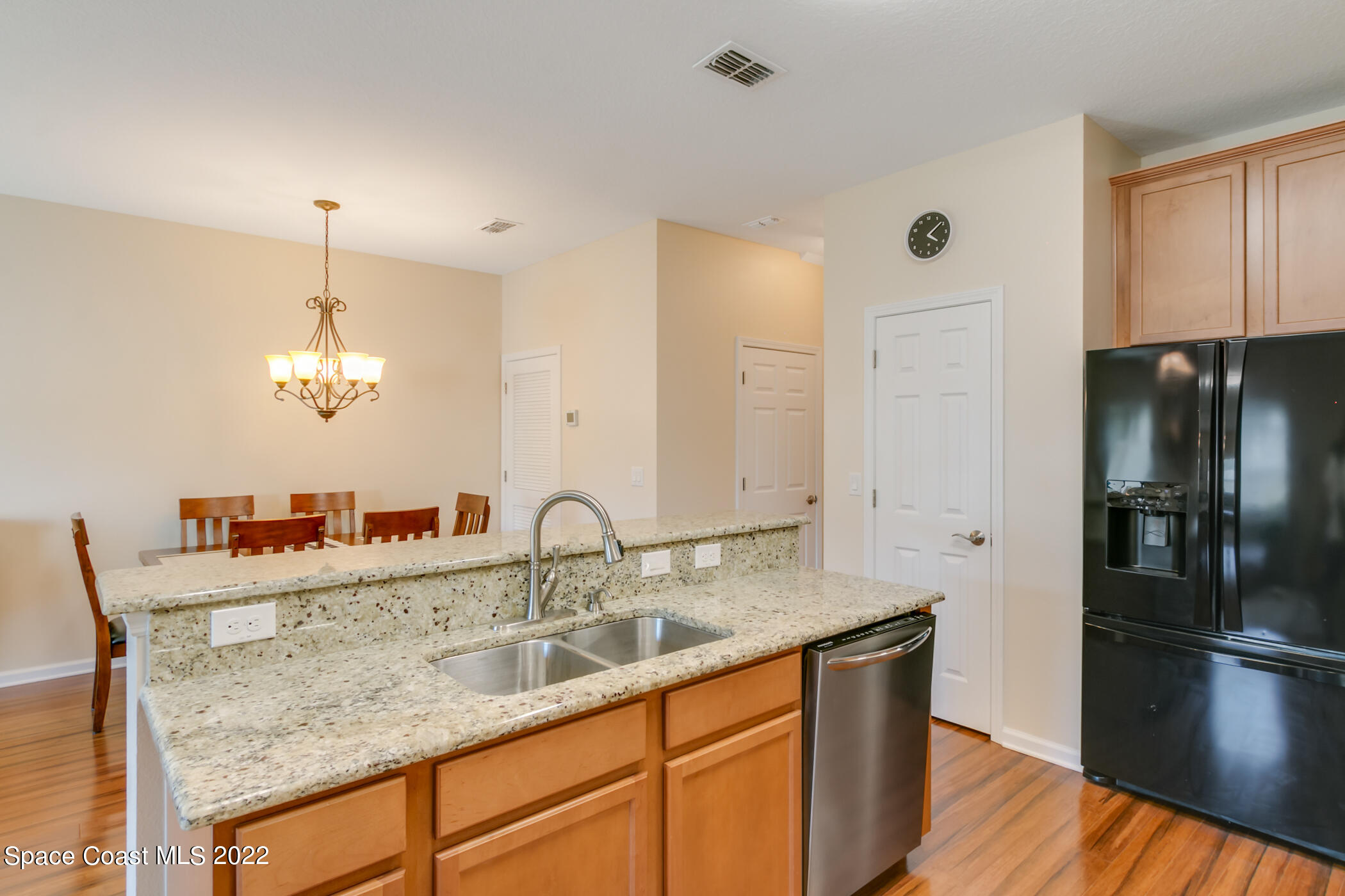 2525 Revolution Street, Unit 104 Melbourne, FL 32935 - Photo 37 of 37 a kitchen with stainless steel appliances granite countertop a sink refrigerator and cabinets