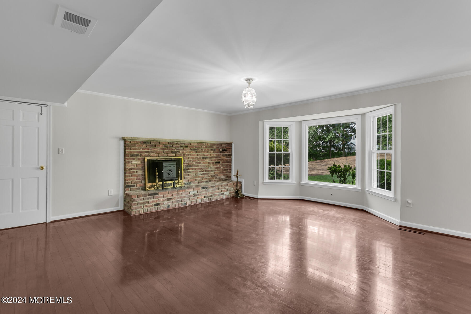 36 Maple Drive Colts Neck, NJ 07722 - Photo 14 of 32 a view of empty room with wooden floor and fireplace