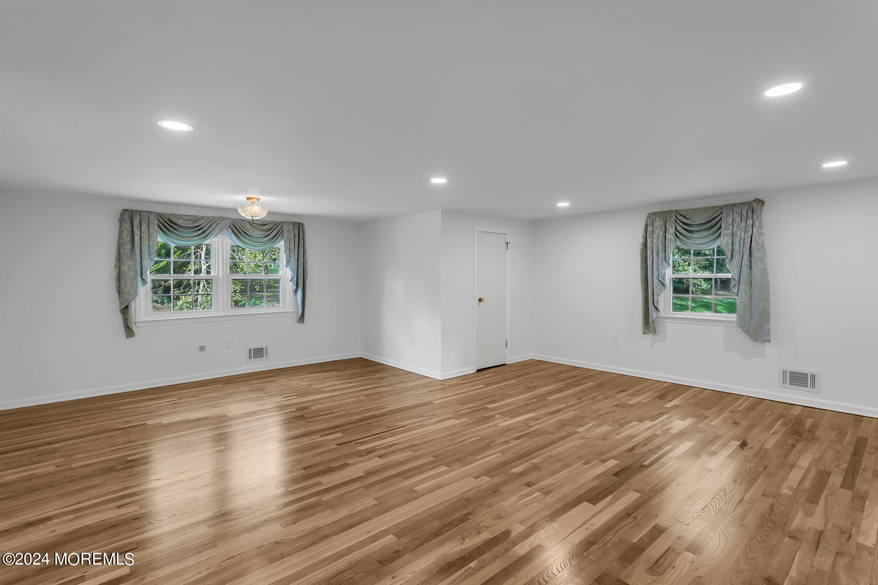 36 Maple Drive Colts Neck, NJ 07722 - Photo 16 of 32 a view of an empty room with wooden floor and a window