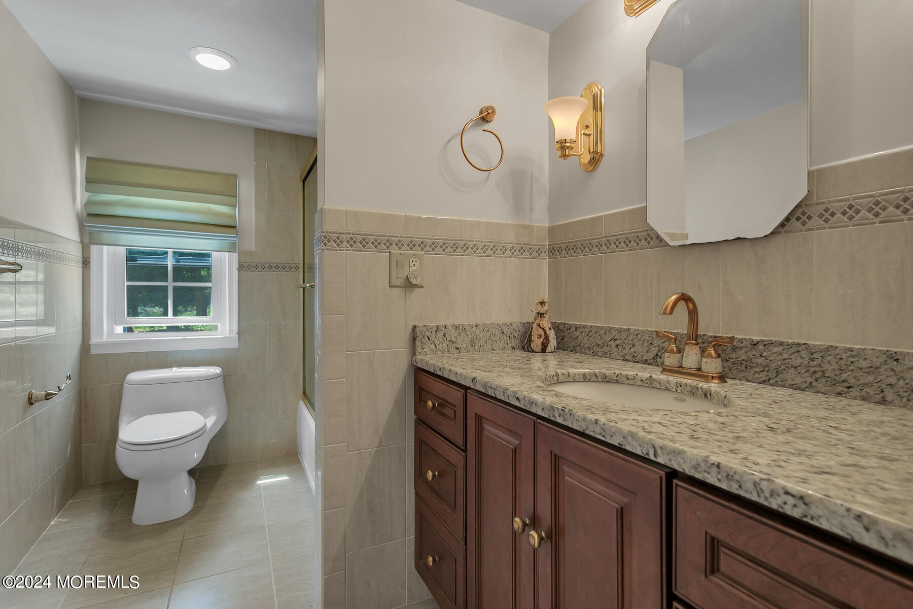 36 Maple Drive Colts Neck, NJ 07722 - Photo 18 of 32 a bathroom with a granite countertop sink a toilet and a mirror