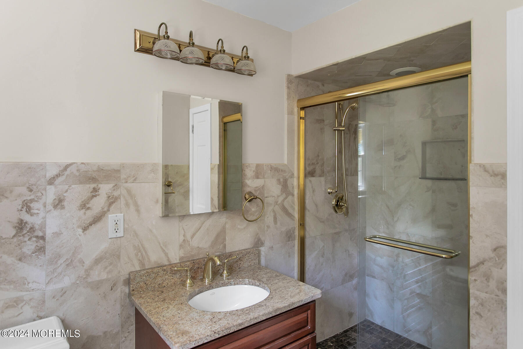 36 Maple Drive Colts Neck, NJ 07722 - Photo 24 of 32 a bathroom with a granite countertop shower sink and mirror