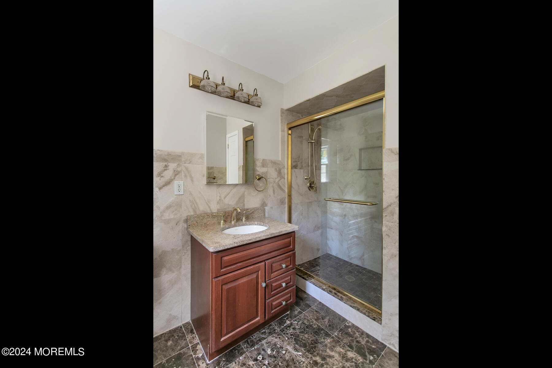 36 Maple Drive Colts Neck, NJ 07722 - Photo 25 of 32 a bathroom with a granite countertop sink a mirror and a shower