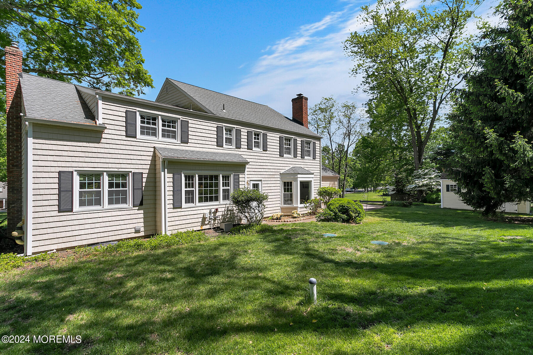 36 Maple Drive Colts Neck, NJ 07722 - Photo 31 of 32 a front view of a house with a garden