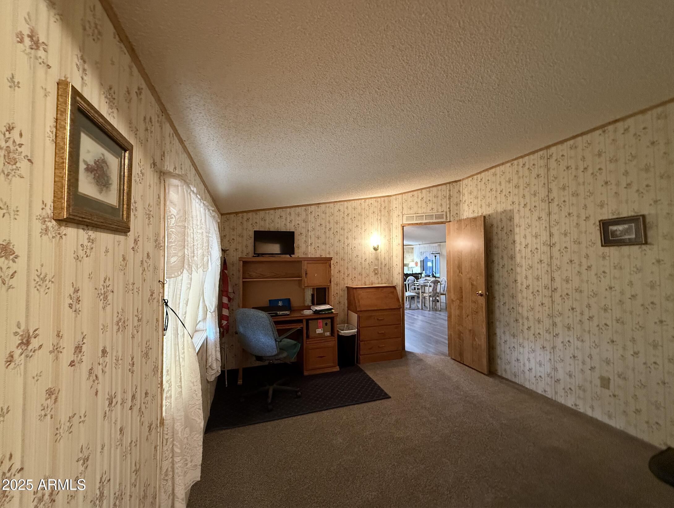 1935 North Tortoise Trail Dragoon, AZ 85609 - Photo 14 of 23 a view of a livingroom with furniture a flat screen tv and refrigerator