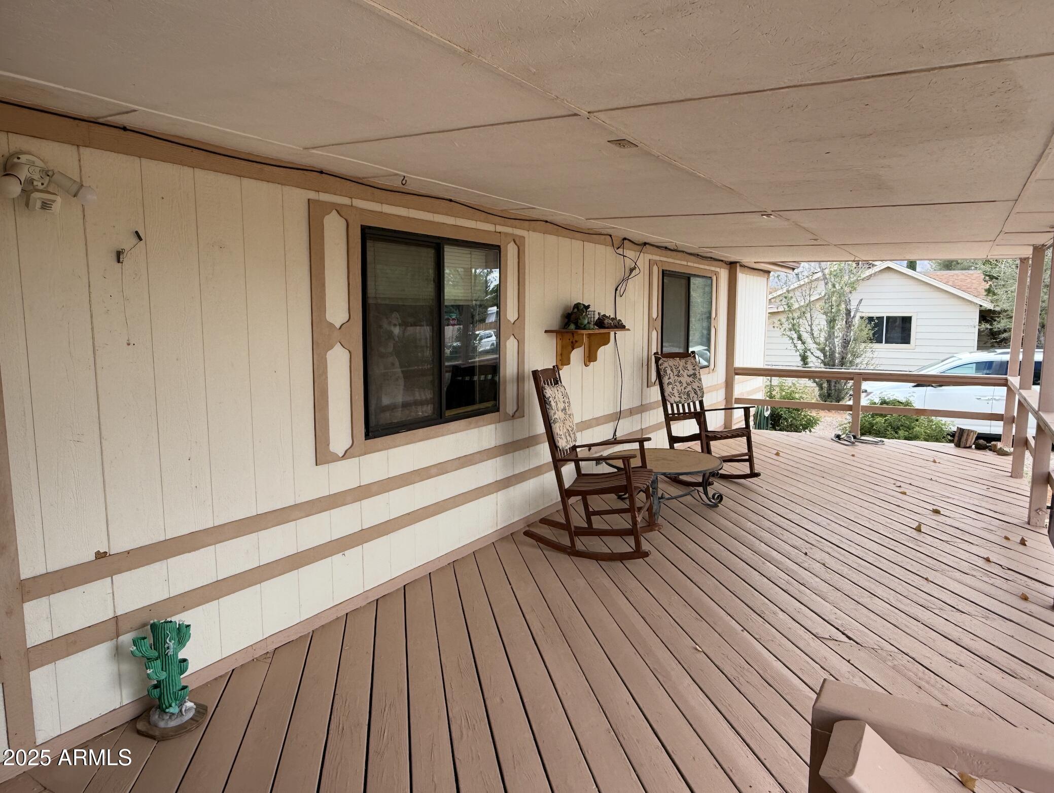 1935 North Tortoise Trail Dragoon, AZ 85609 - Photo 15 of 23 a view of a patio with table and chairs with wooden floor and fence