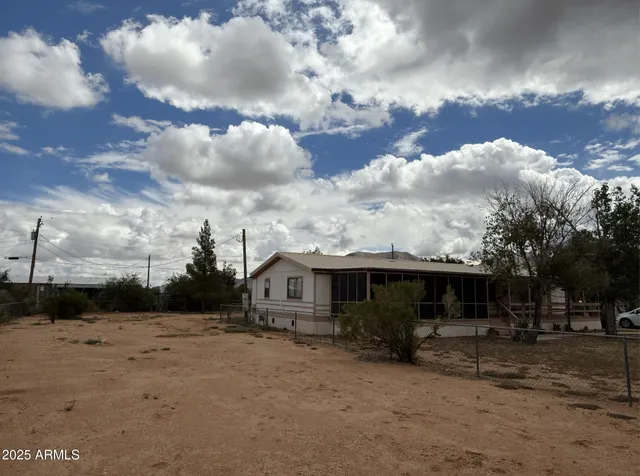 a view of a patio with table and chairs barbeque potted plants and large tree