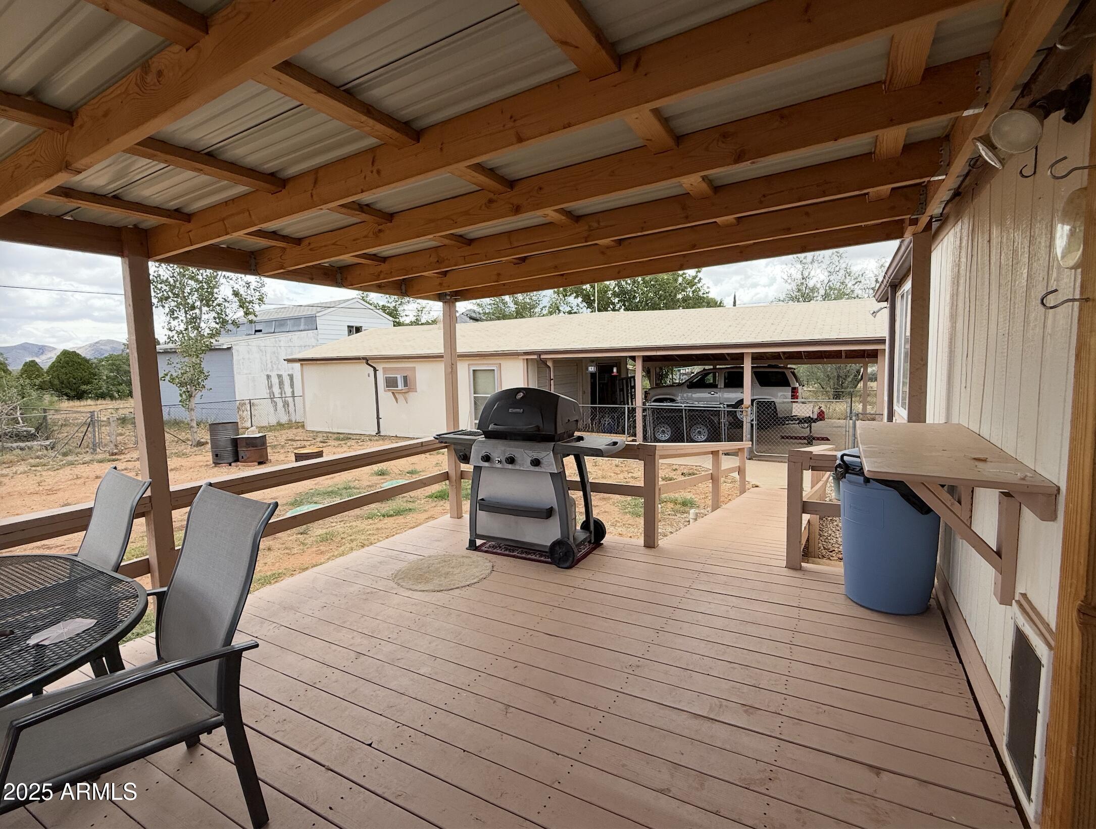 1935 North Tortoise Trail Dragoon, AZ 85609 - Photo 22 of 23 a view of a patio with table and chairs barbeque potted plants and large tree