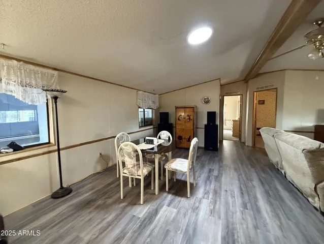 a dining room with furniture and wooden floor