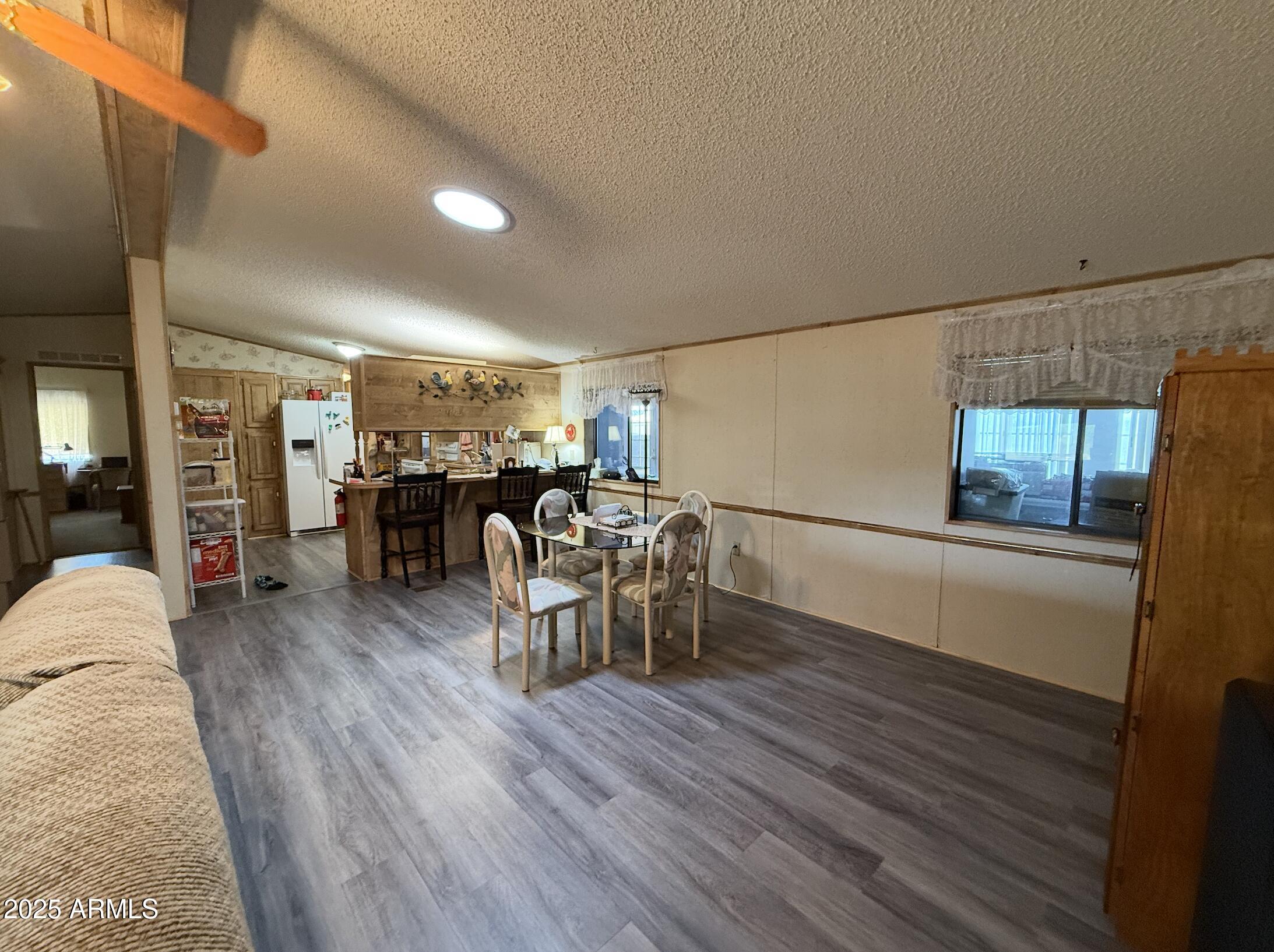 1935 North Tortoise Trail Dragoon, AZ 85609 - Photo 4 of 23 a living room with furniture a wooden floor and next to a window