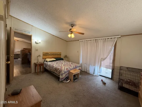 a bedroom with a bed and a ceiling fan