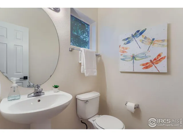 a bathroom with a sink mirror and toilet