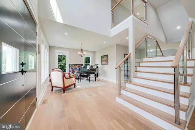 a dining room with furniture a rug a potted plant and wooden floor
