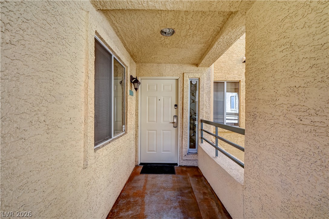 230 East Flamingo Road, Unit 333 Las Vegas, NV 89169 - Photo 6 of 61 Textured stucco walls line a private covered entrance leading to the front door.
