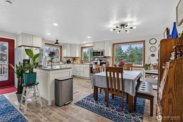 a view of hallway with furniture and a window