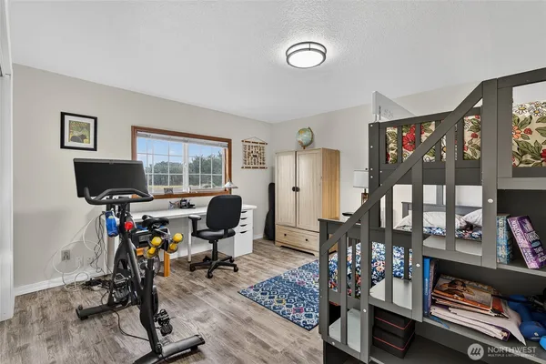 an aerial view of a house with a yard and lake