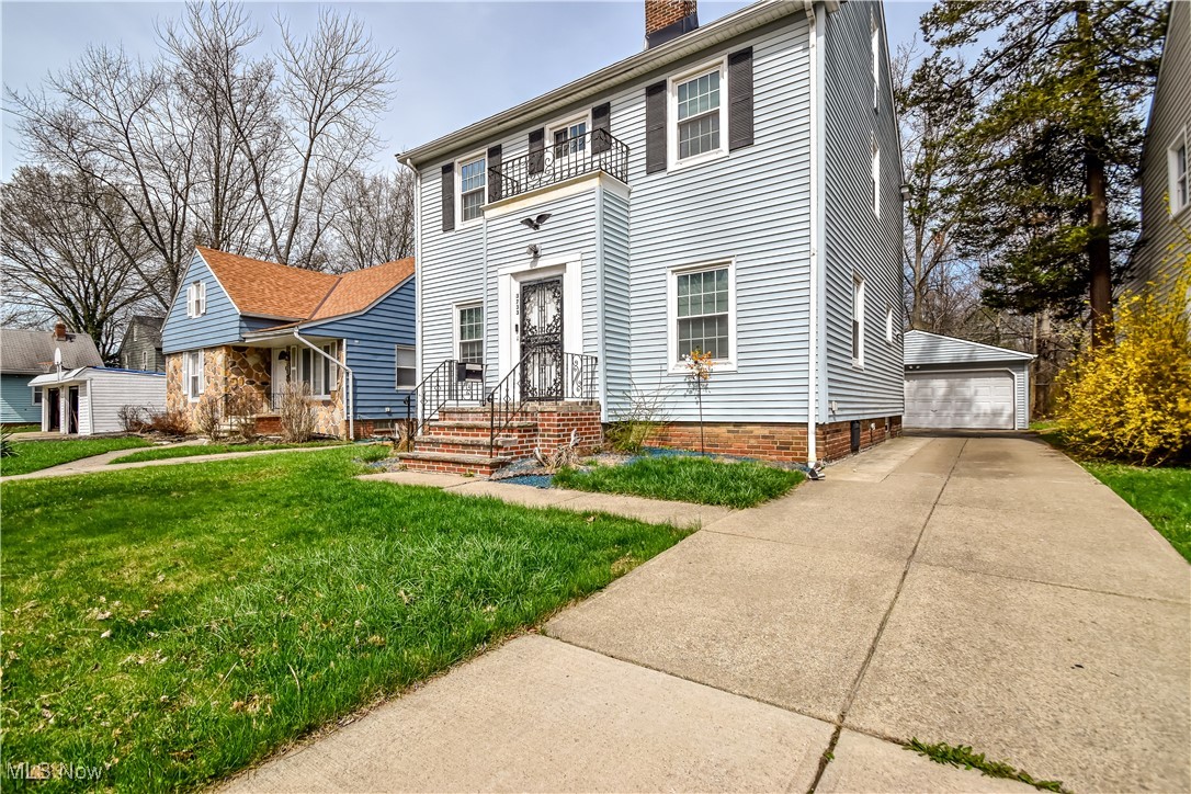 3733 East Antisdale Road Cleveland, OH 44118 - Photo 2 of 28 Colonial home featuring a chimney, an outdoor structure, a balcony, a front lawn, and a detached garage