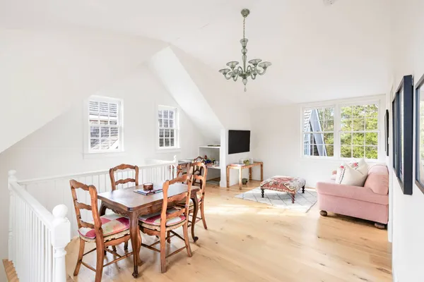 a view of a livingroom and a dining room with furniture window and outside view