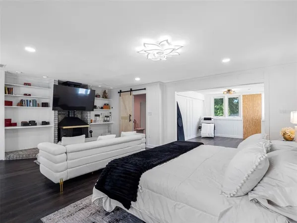 a bedroom with a large bed and a chandelier