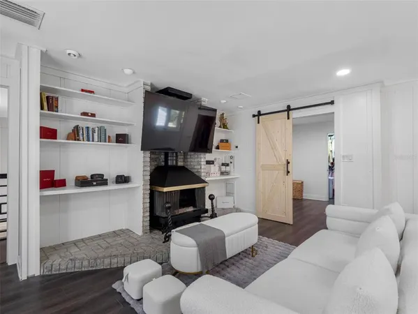 a spacious bedroom with a bed and a chandelier