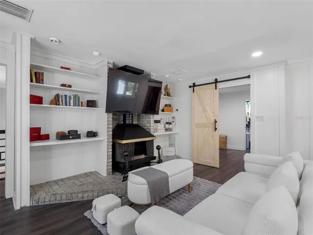 a spacious bedroom with a bed and a chandelier
